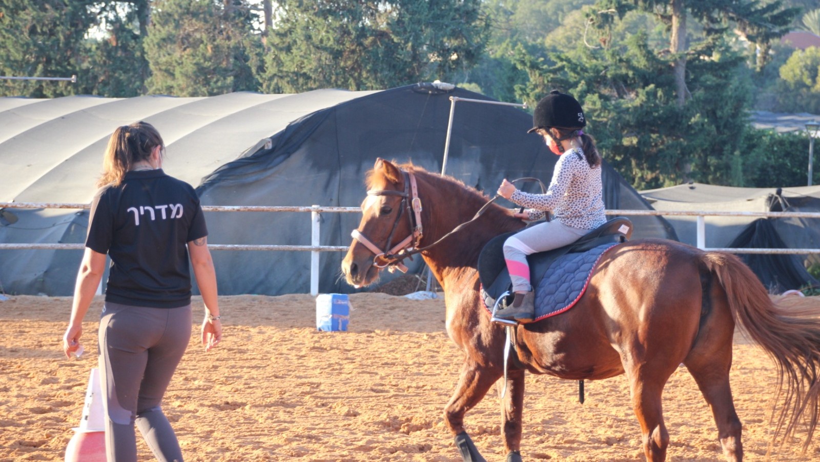 An 8-year-old learns how to ride therapeutic horse Tika. (Courtesy of INTRA)