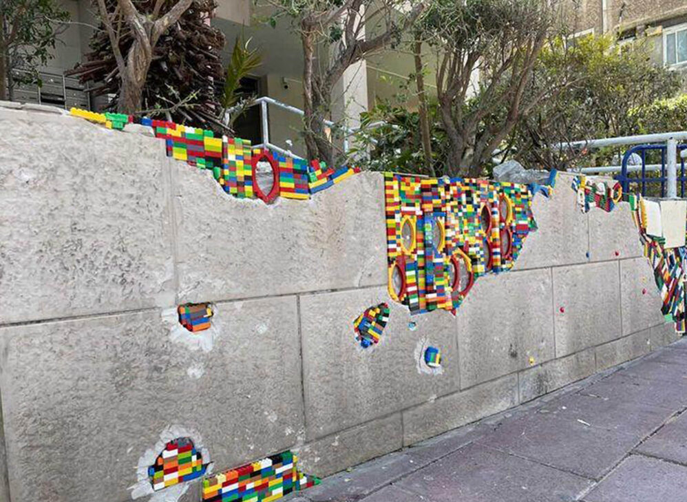 A wall was hit by a rocket in Ramat Gan, Israel, and repaired by Israeli student Raz Sror using Lego bricks. (Raz Sror/Zenger News)