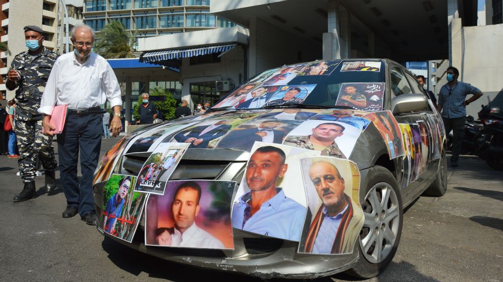 A car parked in front of the Ministry of Justice is covered by the pictures of some victims of the Beirut blast. (Dario Sabaghi) 