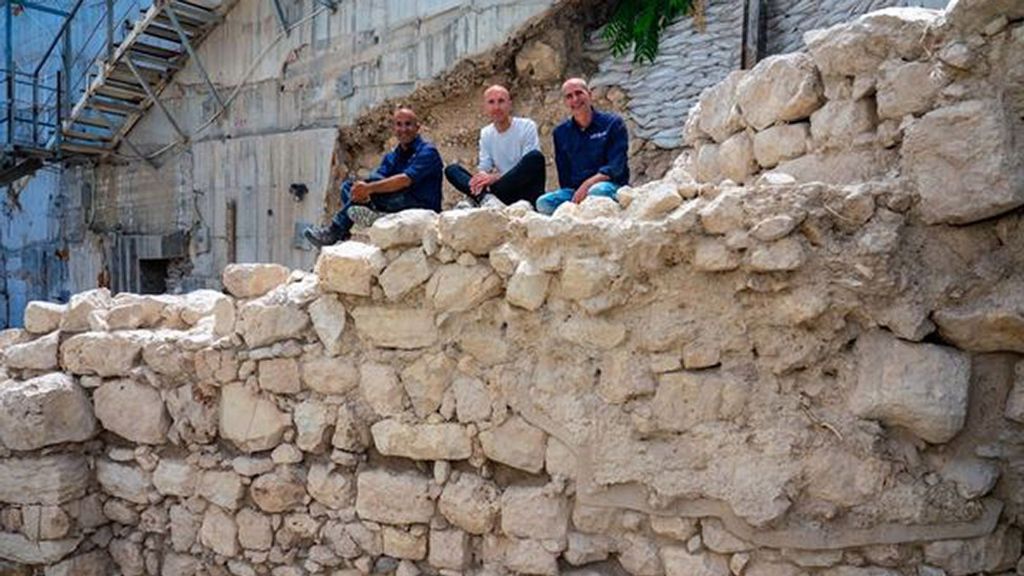 The excavation directors sit on the exposed section of the First Temple-era protective wall on Jerusalem's eastern side. (Yaniv Berman, Israel Antiquities Authority/Zenger)