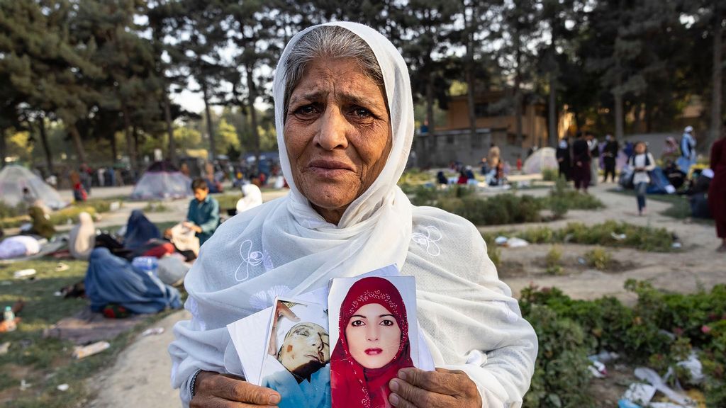 Zoohra, 60, holds the photo of her daughter who she said was killed by the Taliban one month ago at a makeshift IDP camp in Share-e-Naw park to various mosques and schools on August 12, 2021 in Kabul, Afghanistan. (Paula Bronstein/Getty Images)