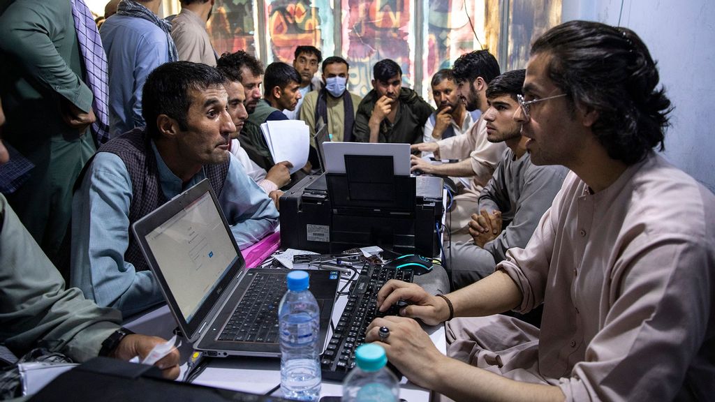 Afghan Special Immigrant Visa (SIV) applicants crowd into the Herat Kabul Internet cafe to apply for the SIV program on August 8, 2021, in Kabul, Afghanistan. Many Afghans are in desperate need of assistance completing the forms and obtaining required human resources letters, a particular challenge for those whose US government work ended years ago. (aula Bronstein/Getty Images)