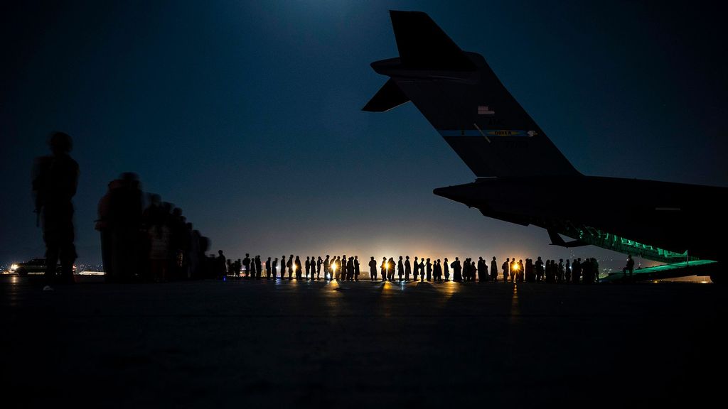 An air crew prepares to load evacuees aboard a C-17 Globemaster III aircraft in support of the Afghanistan evacuation at Hamid Karzai International Airport on August 21, 2021 in Kabul, Afghanistan. (Taylor Crul/U.S. Air Force/Getty Images)
