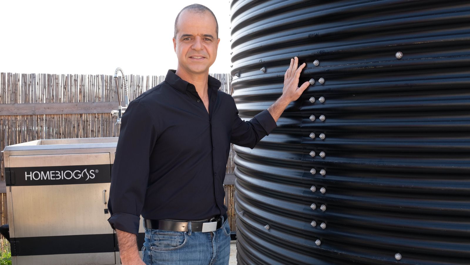 HomeBiogas CEO Oshik Efrati alongside one of the company’s systems. (Courtesy of HomeBiogas)