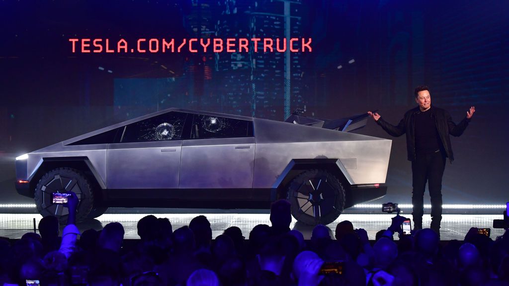 Tesla co-founder and CEO Elon Musk speaks in front of the newly unveiled all-electric battery-powered Tesla's Cybertruck with shattered windows, after a failed resistance test, at Tesla Design Center. Cybertruck, which has yet to be launched officially, has reportedly fetched $400,000 at an auction. FREDERIC J. BROWN/AFP VIA GETTY IMAGES.